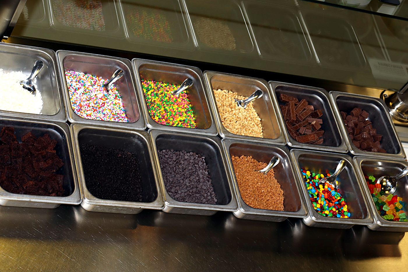 Sweet Lou's topping bar, sprinkles, candy, chocolate and crumbles ready for scooping